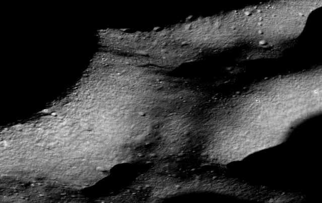 Oblique view of the Shacklton crater rim in the vicinity of the lunar South Pole, captured by the Lunar Reconnaissance Orbiter Camera.