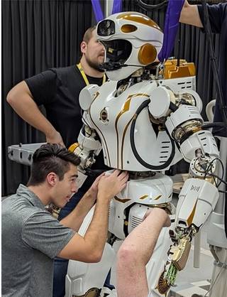 NASA Dexterous Robotics engineers Alex Sowell and Misha Savchenko setting up the Valkyrie robot at Woodside Energy.