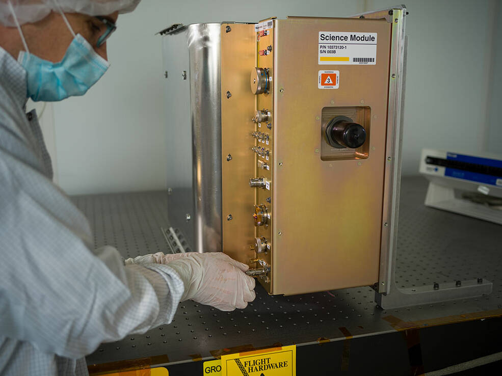 A member of the Cold Atom Lab mission team works on the Quantum Observer Module