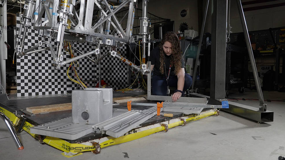 Morgan Montalvo, another JPL engineer, sets guardrails on the floor