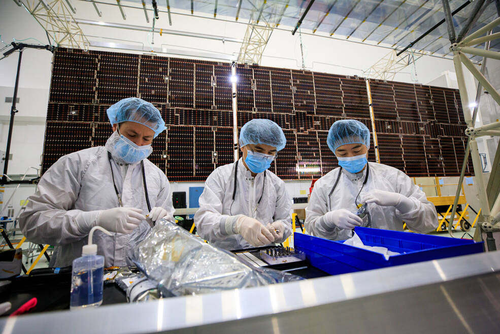 Team members prepare to integrate one of two solar arrays on NASAs Psyche spacecraft