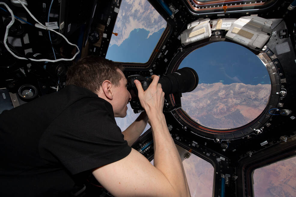 NASA astronaut Woody Hoburg points a camera out the center window of the station cupola to capture an image of Saudi Arabia as part of Crew Earth Observations or CEO.