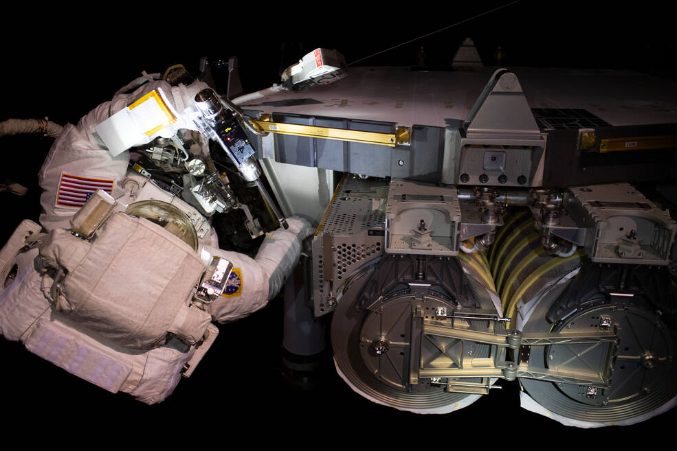 NASA astronaut Stephen Bowen readies one of the Roll-out Solar Arrays (IROSA) for installation during a spacewalk.