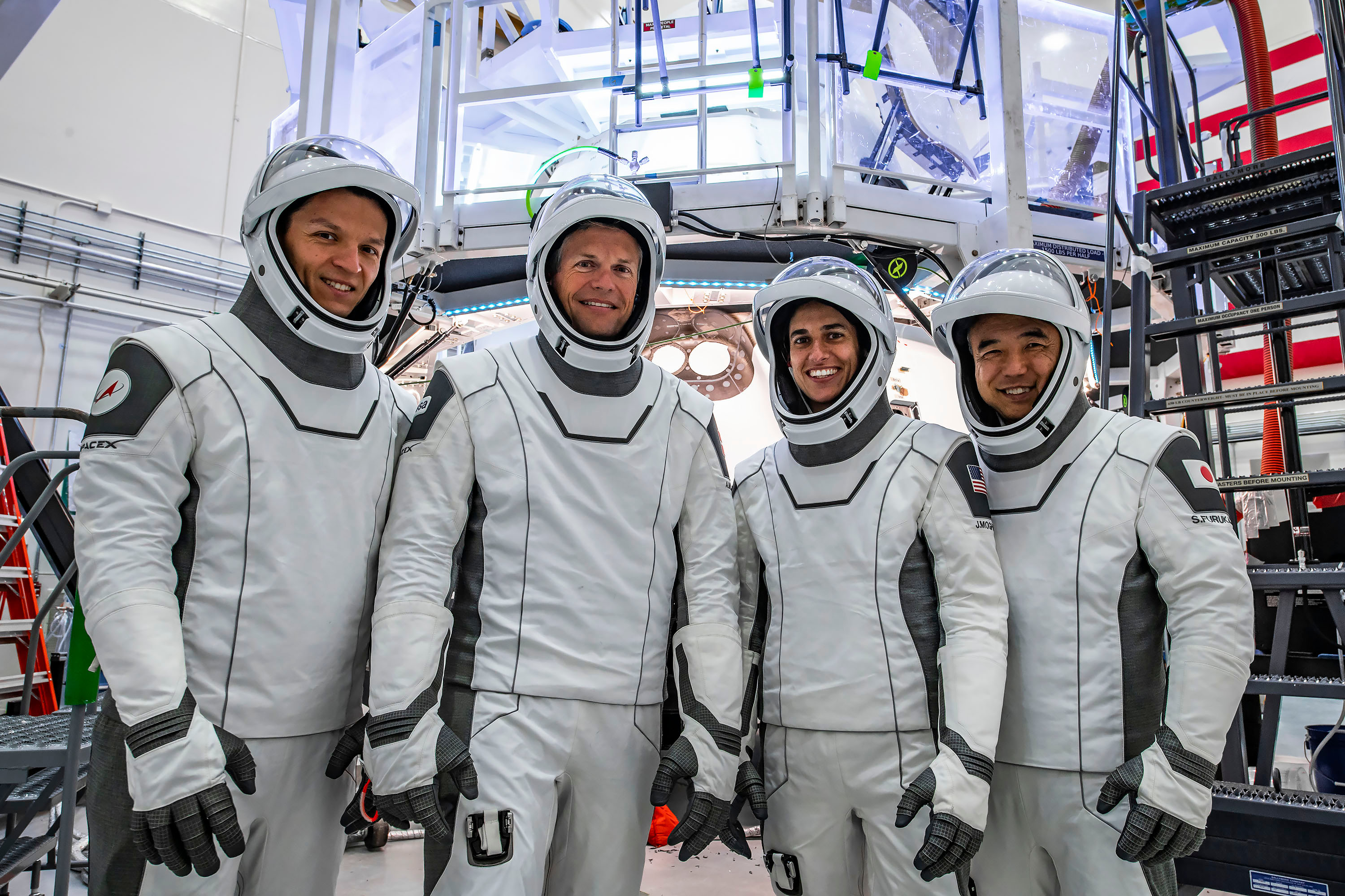 The crew of NASA's SpaceX Crew-7 mission poses for a photo in their SpaceX suits before their mission to the International Space Station.