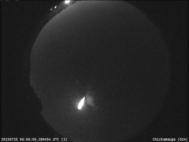 A bright white streak is in the bottom left corner on a dark grey almost black background.