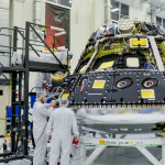 Technicians work on the Orion crew module for NASAs Artemis II mission inside the Neil A. Armstrong Operations and Checkout Building at the agencys Kennedy Space Center in Florida.