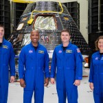 The Artemis II crew is shown inside the Neil Armstrong Operations and Checkout Building at NASA’s Kennedy Space Center in Florida in front of their Orion crew module