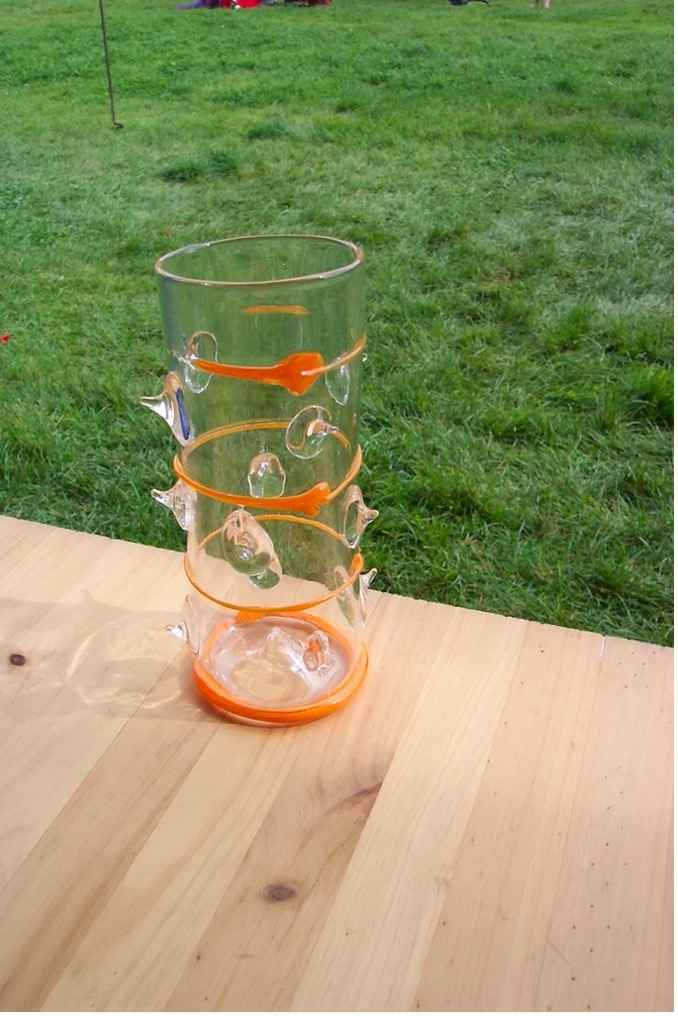 Orange-clear soda-lime glass piece crafted by Cassie through glassblowing