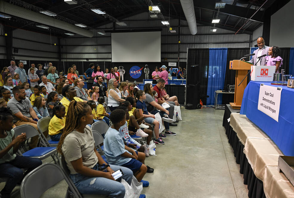 Larry Mack, deputy director of the Office of Human Capital at NASAs Marshall Space Flight Center, and his daughter, Alexis Mack, welcome families to the 2023 Take Our Children to Work Day in Building 4316 on July 28.