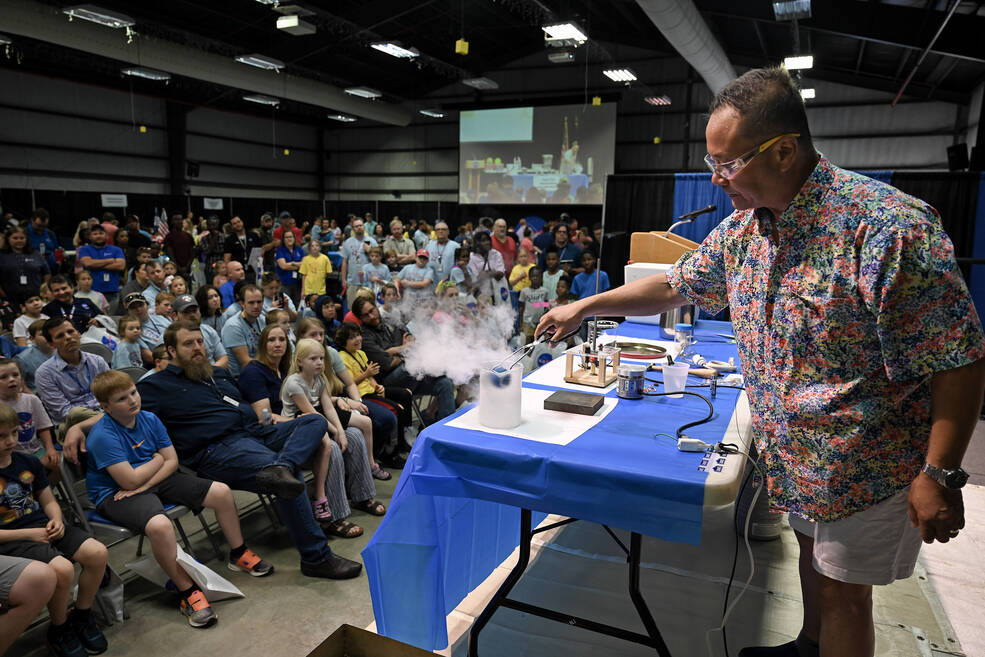 Howard Soohoo, a chief engineer supporting Marshalls Science Research and Projects Division, dips a Styrofoam ball into liquid nitrogen during an activity at Take Our Children to Work Day.