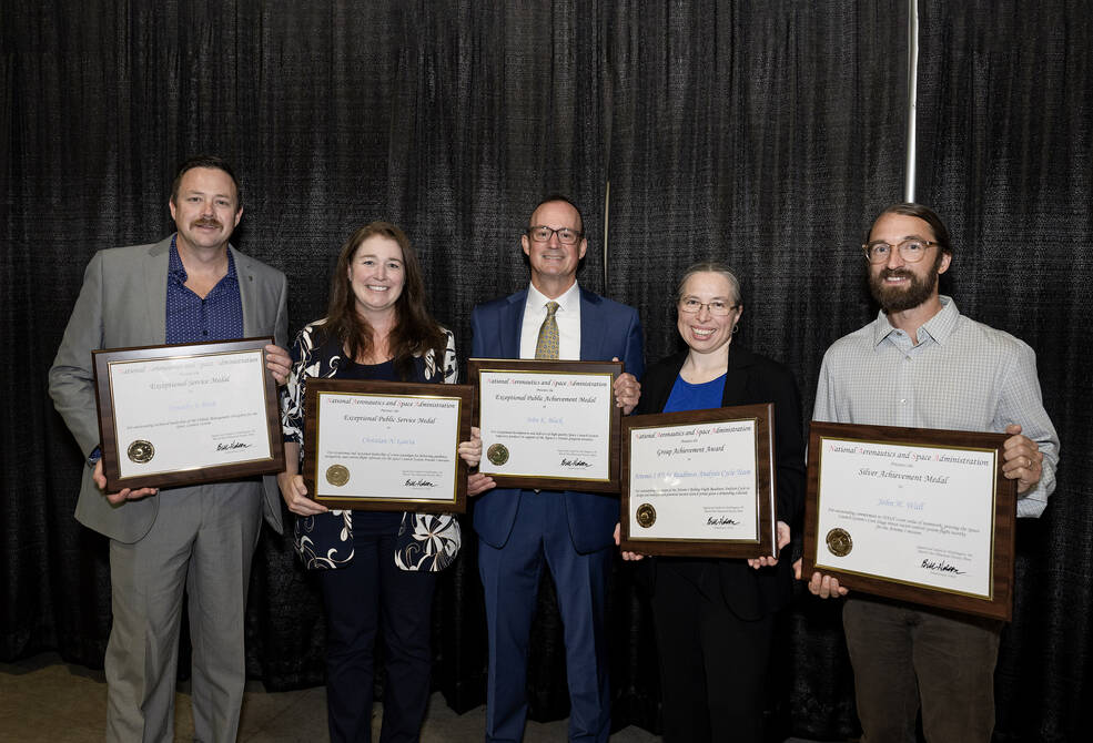 Some of Marshalls recipients display their plaques at the agency honor awards. From left are Timothy Bush, Christian Garcia, John Black, Robin Pinson, and John Wall.