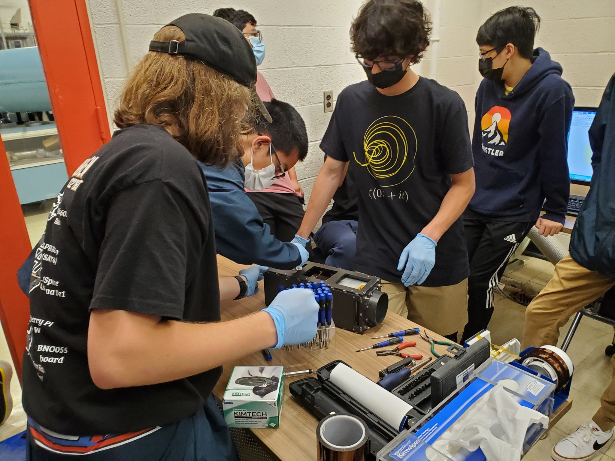 A group of students at Thomas Jefferson High School for Science and Technology work on their CubeSat