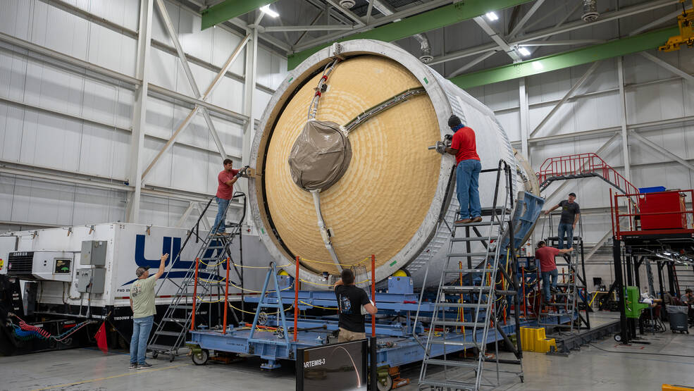 ULA technicians in Decatur, Alabama, prepare the ICPS (interim cryogenic propulsion stage) for boxing July 29. The SLS upper stage is raised and lowered into a container for shipment to the Space Coast.