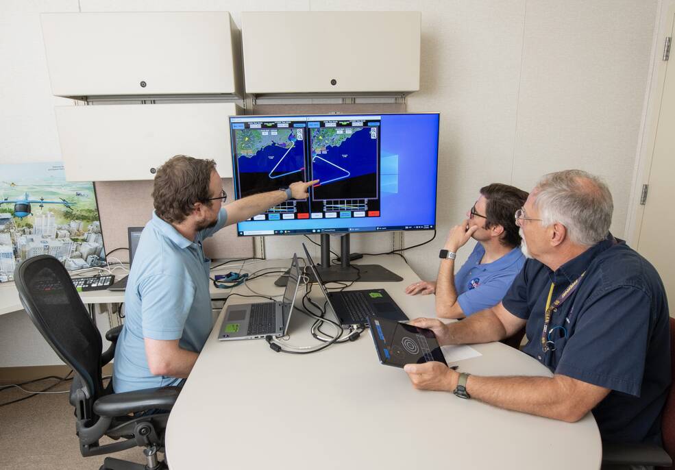 NASA lead software developer, Ethan Williams, left, pilot Scott Howe, and operations test consultant Jan Scofield run a flight path management software simulation at NASAs Armstrong Flight Research Center in Edwards, California.