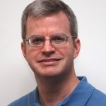 Portrait of William Brinckerhoff in a blue collared shirt