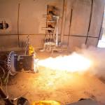 A fire test for a motor that has flames coming out of the end.