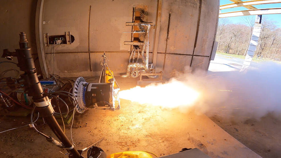 A fire test for a motor that has flames coming out of the end.