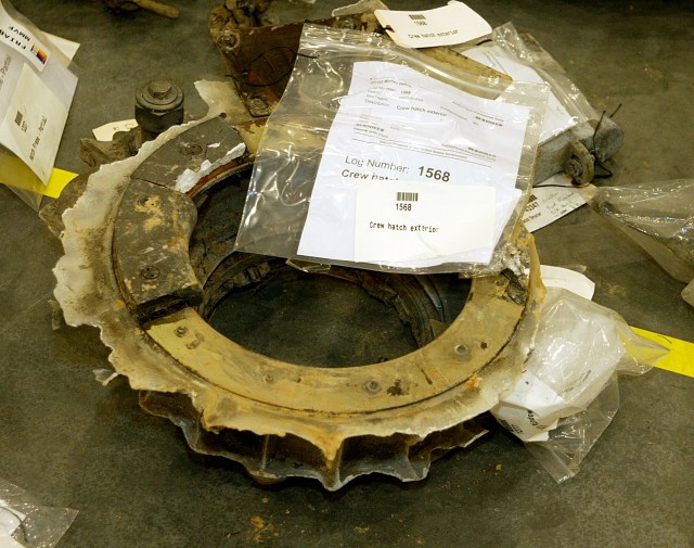 A ring-shaped metal piece of Columbia on the floor of the Columbia reconstruction hangar