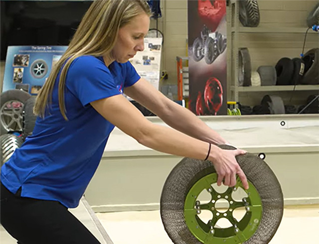 Space tire engineer Heather Oravec rolls a flexible tire design over a rock in a laboratory as she discusses her unexpected “Surprisingly STEM” journey to a NASA career