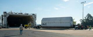 ULA crews guide the ICPS (interim cryogenic propulsion stage) for NASAs SLS (Space Launch System) rocket to the loading dock and awaiting barge in Decatur, Alabama, for shipment to Florida, July 31.