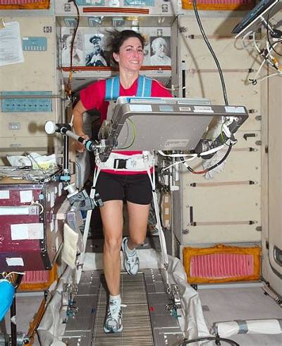 Astronaut with sensors on running on a treadmill
