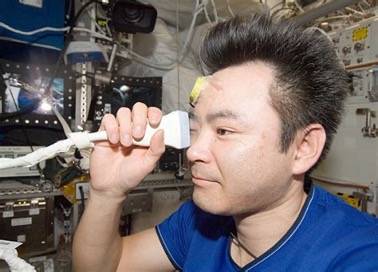 Astronaut examining eye with tool