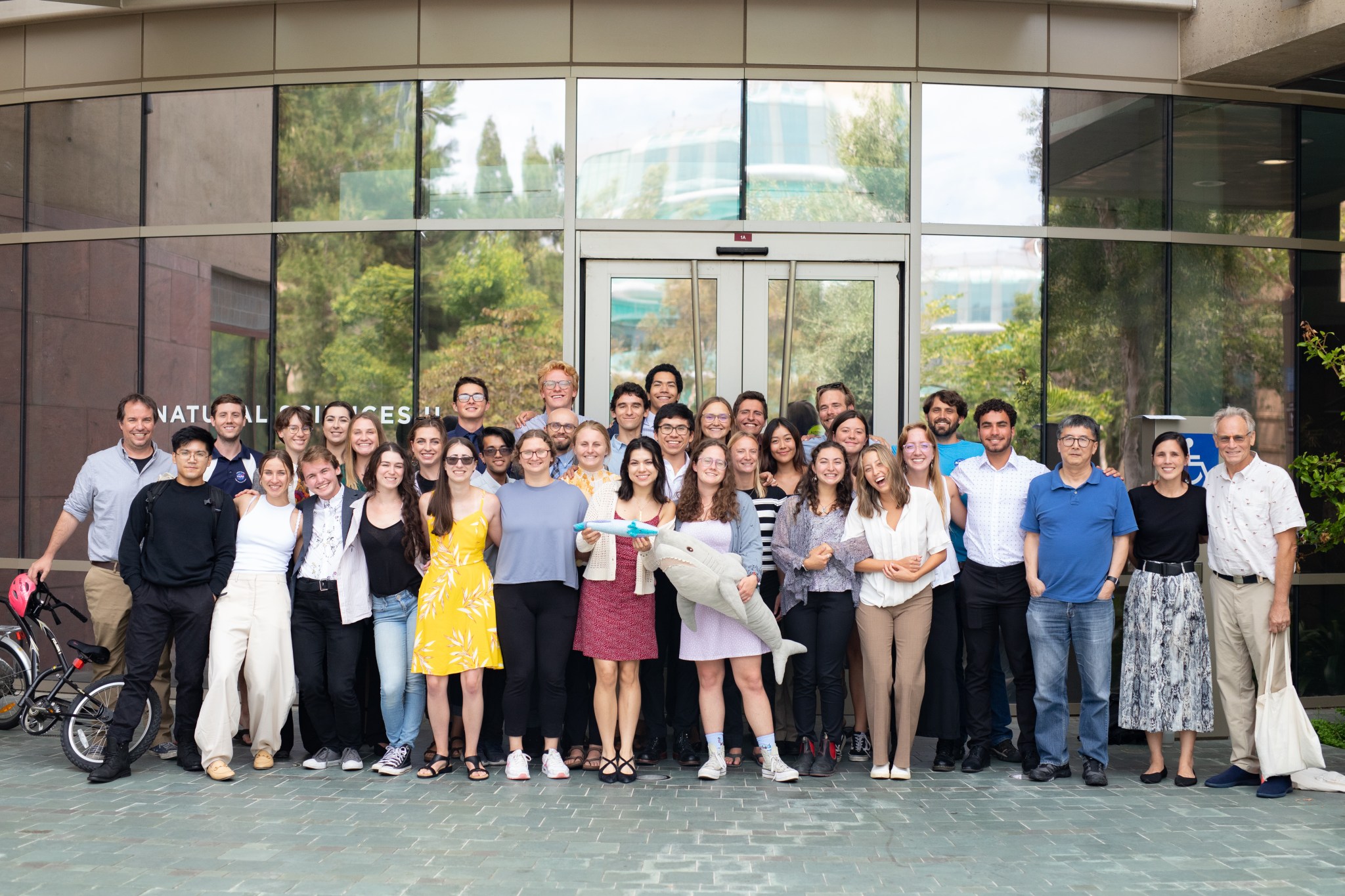 Students and staff of the 2023 SARP West internship program gather outside the Natural Sciences building at UC Irvine, after concluding the program with research presentations and a graduation ceremony.