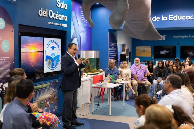 OCEANOS PI Juan Torres-Perez delivers the opening address of the final presentations to a crowded room at the EcoExploratorio: el Museo de Ciencias de Puerto Rico.