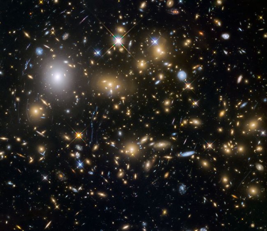 Photo of black background with colorful galaxies in the background.