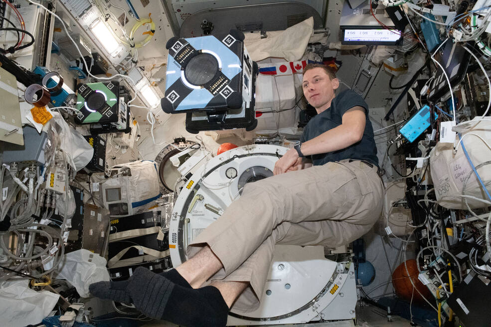 NASA astronaut Woody Hoburg tests one of the space stations Astrobee robots for Zero Robotics, a student competition to write software to control the free-flying robots.