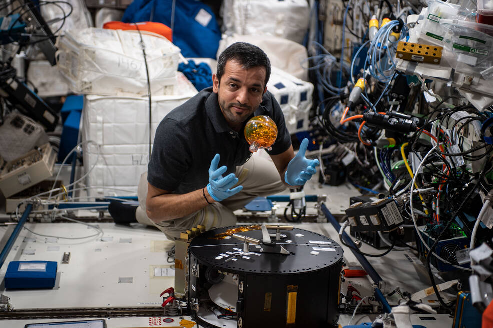 A floating sphere stands in for a spacecraft fuel tank as UAE astronaut Sultan Alneyadi works on the FLUIDICS investigation.