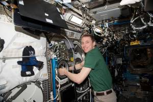 Astronaut Woody Hoburg works on physics research