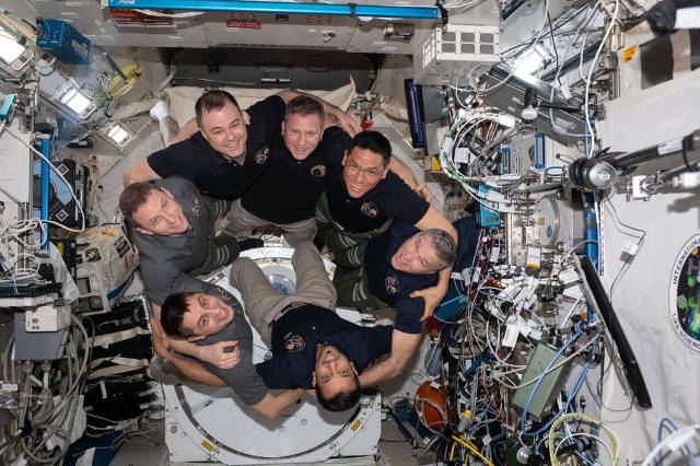 The seven-member Expedition 69 crew gathers for a portrait