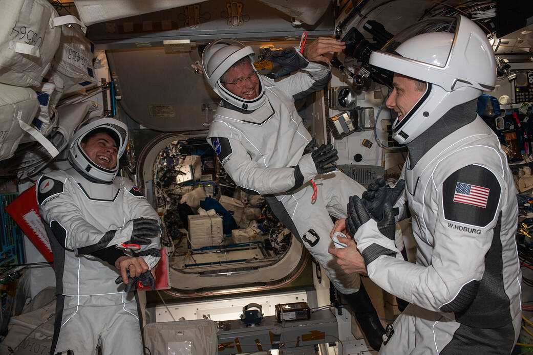 Expedition 69 crew mates wear SpaceX pressure suits