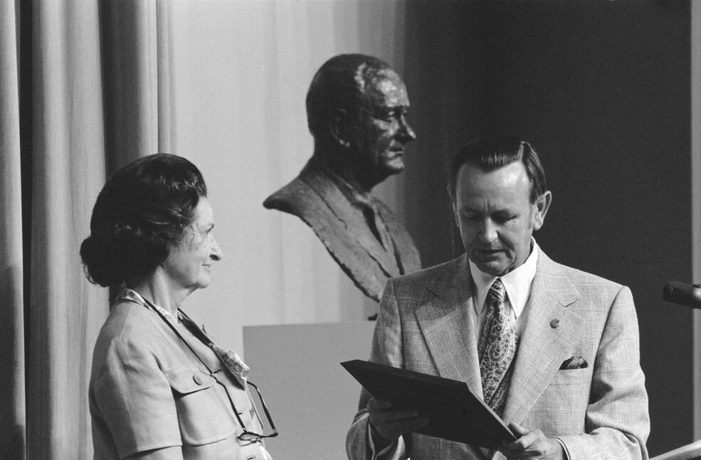 Christopher Kraft presents a plaque to Lady Bird Johnson