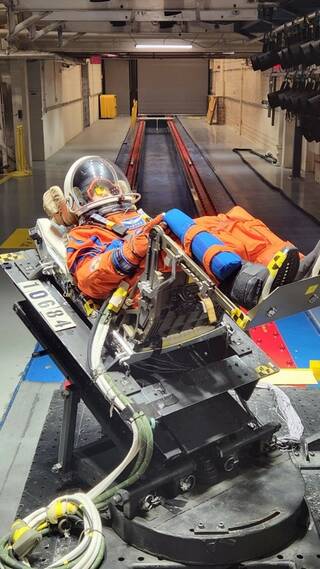 NASAs Moonikin Campos sitting in an Orion chair