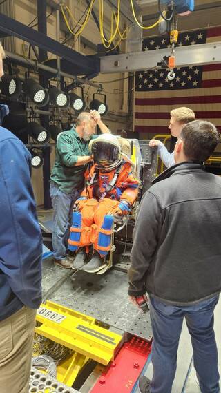 NASA engineers setting up Moonikin Campos