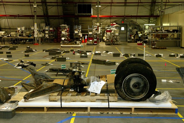 Debris of Columbia collected in a hangar. The nose landing gear is featured in the center of the image.