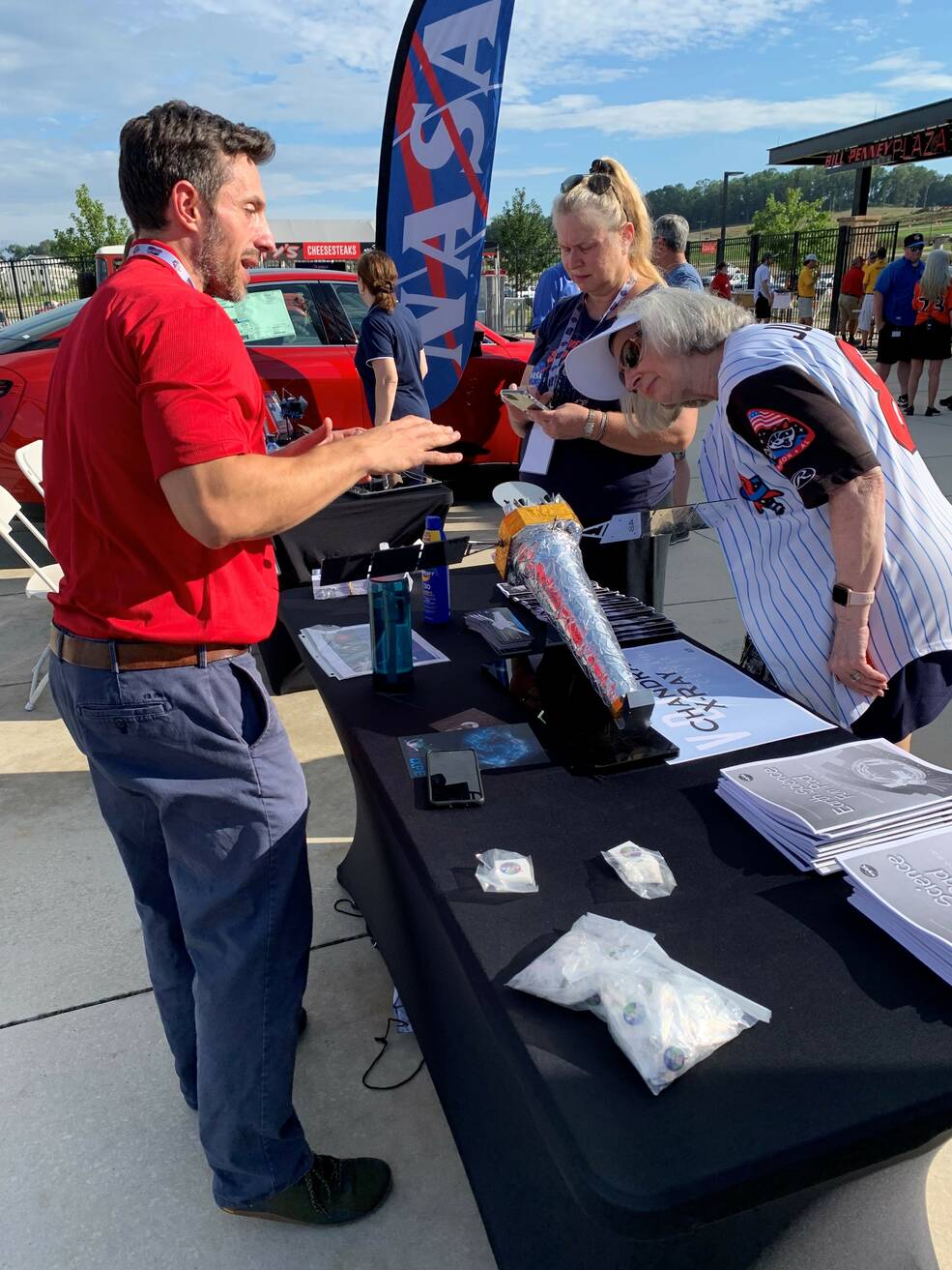 Stephen Bongiorno, left, discusses the 25th anniversary of NASAs Chandra X-ray Observatory with fans during Space Night with the Rocket City Trash Pandas, Huntsvilles minor league baseball team, Aug. 8.