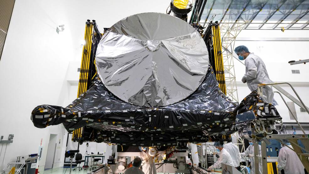 Psyche mission team members prepare the spacecraft at a facility near NASAs Kennedy Space Center in Florida in late July, just after the solar arrays were folded and stowed.