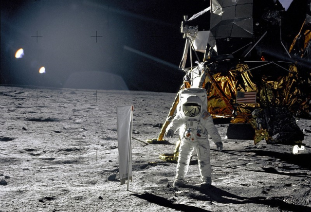 Astronaut Edwin E. Aldrin, Jr., Lunar Module pilot, is photographed during the Apollo 11 extravehicular activity (EVA) on the lunar surface. In the right background is the Lunar Module "Eagle." On Aldrin's right is the Solar Wind Composition (SWC) experiment already deployed. This photograph was taken by Neil A. Armstrong with a 70mm lunar surface camera.