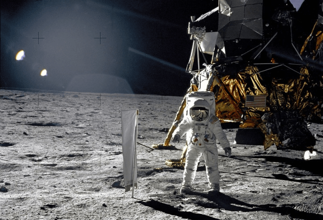 Astronaut Edwin E. Aldrin, Jr., Lunar Module pilot, is photographed during the Apollo 11 extravehicular activity (EVA) on the lunar surface. In the right background is the Lunar Module "Eagle." On Aldrin's right is the Solar Wind Composition (SWC) experiment already deployed. This photograph was taken by Neil A. Armstrong with a 70mm lunar surface camera.