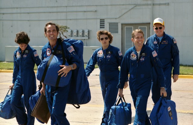 The STS 41-G crew leaves the hanger at Ellington Air Force Base for departure for the Kennedy Space Center (KSC) and the STS 41-G mission.