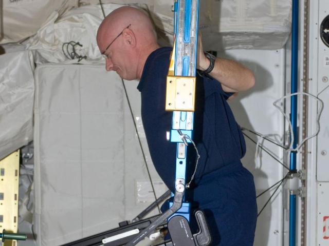 NASA astronaut Scott Kelly, Expedition 25 flight engineer, exercises using the advanced Resistive Exercise Device (aRED) in the Tranquility node of the International Space Station.