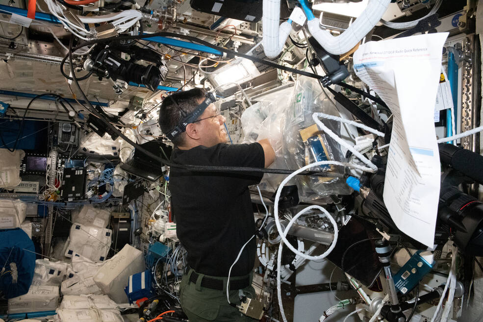 NASA astronaut Frank Rubio replaces components inside the BioFabrication Facility (BFF).