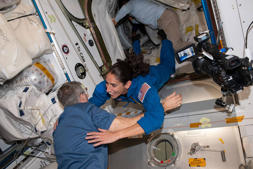 NASA astronaut and Crew-7 Commander, Jasmin Moghbeli, goes for a hug with NASA astronaut Stephen Bowen after entering through the hatch following Crew-7's arrival to the International Space Station on August 27, 2023.