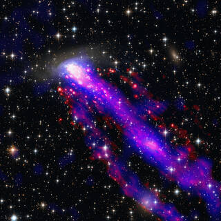 As the galaxy moves through space at 1.5 million miles per hour, it leaves not one â€” but two â€” tails behind it.