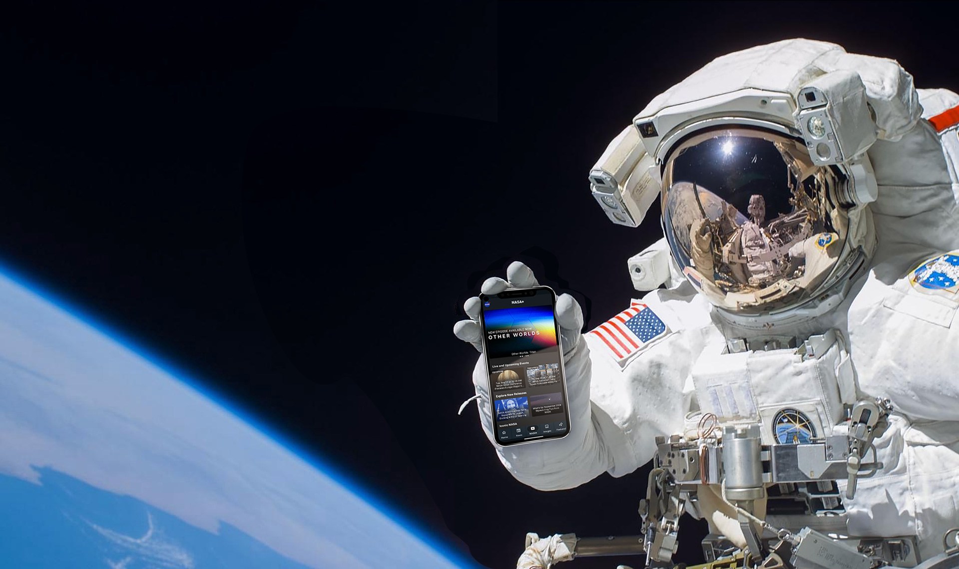 Astronaut holding phone with NASA app while on spacewalk