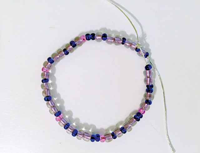 A bracelet made of blue, pink, and clear beads