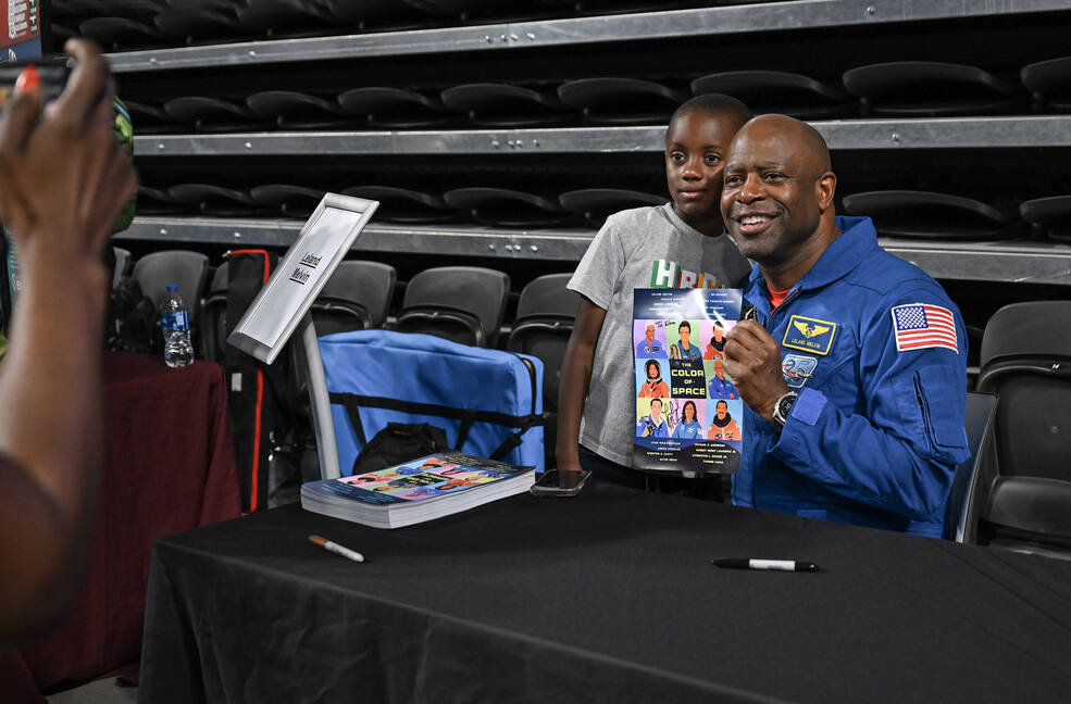 Retired NASA astronaut Leland Melvin smiles for a photo with a young student from the community attending The Color of Space screening Sept. 8 at Alabama A&M University.